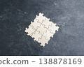 Unfinished wooden jigsaw puzzle on a black background. 138878169