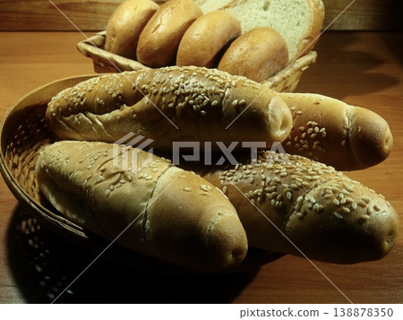 Variety bread rolls in bread basket on wooden table at bakery Variety bread rolls in bread basket on wooden table at bakery 138878350