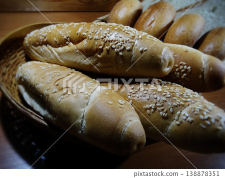 Sesame grain buns and wheat rolls on wooden table close up stock photo Sesame grain buns and wheat rolls on wooden table close up stock photo 138878351