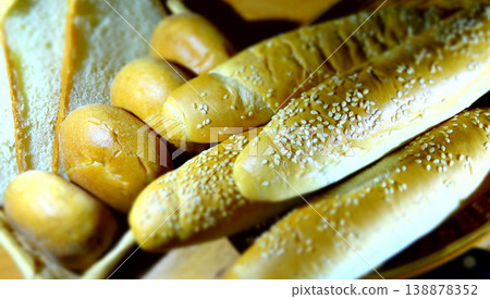 Sesame rolls, round buns and sliced wheat bread in eco friendly style Sesame rolls, round buns and sliced wheat bread in eco friendly style 138878352