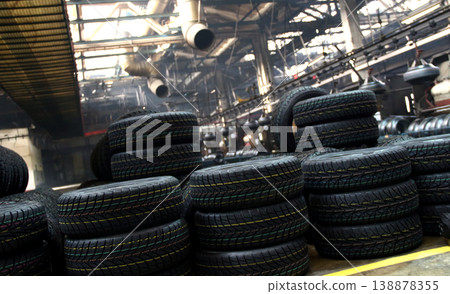Tires production plant site. New cars tires stacking up on the workshop floor Tires production plant site. New cars tires stacking up on the workshop floor 138878355