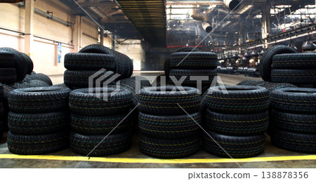 Stacking car tires on the plant floor after production on rubber manufacture Stacking car tires on the plant floor after production on rubber manufacture 138878356