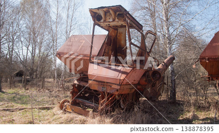 Rusty Harvester In Belarus Exclusion Zone, Overgrown Field And Saplings Reclaim Corroded Body, Peeling Paint, Rusty Harvester In Belarus Exclusion Zone, Overgrown Field And Saplings Reclaim Corroded Body, Peeling Paint, 138878395