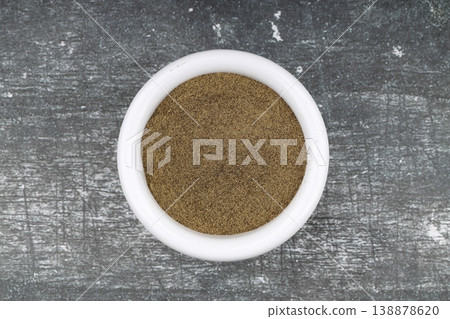 Freshly ground organic black pepper in rustic bowl over wooden surface. Healthy food seasoning Freshly ground organic black pepper in rustic bowl over wooden surface. Healthy food seasoning 138878620