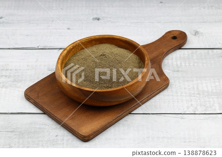 Freshly ground organic black pepper in rustic bowl over wooden surface. Healthy food seasoning Freshly ground organic black pepper in rustic bowl over wooden surface. Healthy food seasoning 138878623