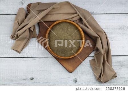 Freshly ground organic black pepper in rustic bowl over wooden surface. Healthy food seasoning Freshly ground organic black pepper in rustic bowl over wooden surface. Healthy food seasoning 138878626