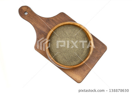 Ground black pepper spice in a wooden bowl isolated on white background. Top view, close-up Ground black pepper spice in a wooden bowl isolated on white background. Top view, close-up 138878630