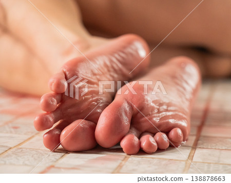 Foot fetish. A woman pours wine on her feet. Foot fetish. A woman pours wine on her feet. 138878663