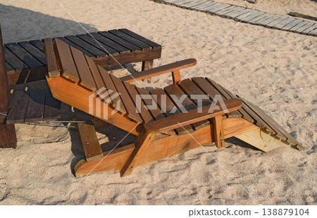 Wooden chaise lounge on the beach Wooden chaise lounge on the beach 138879104