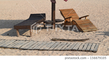 Wooden chaise lounge on the beach Wooden chaise lounge on the beach 138879105