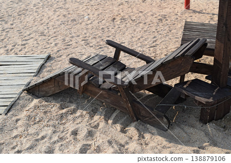 Wooden chaise lounge on the beach Wooden chaise lounge on the beach 138879106