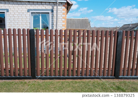 Modern brown metal euro fence panels home garden w section palisade picket with vertical slats and black posts Modern brown metal euro fence panels home garden w section palisade picket with vertical slats and black posts 138879325