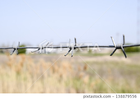 Barbed wire. Barbed wire fencing. The constraint symbol. Barbed wire. Barbed wire fencing. The constraint symbol. 138879556