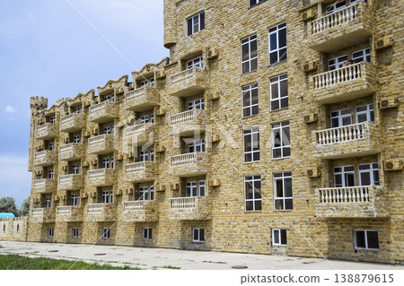 The hotel building, covered with decorative stone. Multi-storey hotel with a decorative trim, which is called Dagestani stone The hotel building, covered with decorative stone. Multi-storey hotel with a decorative trim, which is called Dagestani stone 138879615