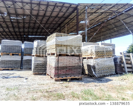 Tiles piled in pallets. Warehouse paving slabs in the factory for its production. Tiles piled in pallets. Warehouse paving slabs in the factory for its production. 138879635