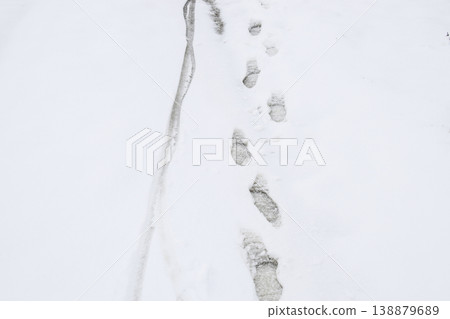 Human footprints in the snow. The path in the snow Human footprints in the snow. The path in the snow 138879689