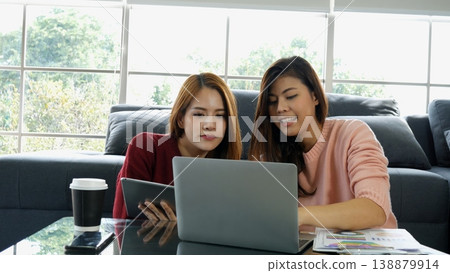 Happy success business woman partner working together in company office corporate executive teamwork. Meeting Executive Asian business woman using laptop office desk with fist arm raised win happiness Happy success business woman partner working together in company office corporate executive teamwork. Meeting Executive Asian business woman using laptop office desk with fist arm raised win happiness 138879914