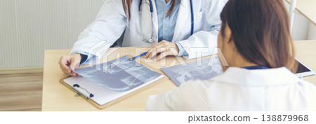 Banner hands of two women doctor medical lab discussing together healthcare teamwork. Panorama Two asian women doctors meeting write prescription medical clinic office using laptop with copy space. Banner hands of two women doctor medical lab discussing together healthcare teamwork. Panorama Two asian women doctors meeting write prescription medical clinic office using laptop with copy space. 138879968