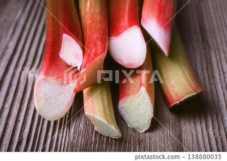 Close up of rhubarb stems on rustic wooden board Close up of rhubarb stems on rustic wooden board 138880035