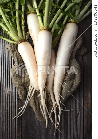 Daikon radish with long roots on textured wooden background Daikon radish with long roots on textured wooden background 138880042