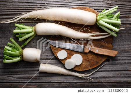 Daikon radish with slices on wooden table Daikon radish with slices on wooden table 138880043