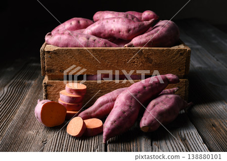 Sweet potato with sliced rounds in wooden box. 138880101