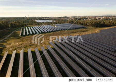 Aerial view of large solar farm with panel rows 138880860