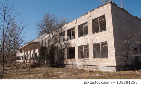 Deserted School Facade With Broken Windows, Peeling Plaster And Empty Classrooms Visible Through Glass, Deserted School Facade With Broken Windows, Peeling Plaster And Empty Classrooms Visible Through Glass, 138881255