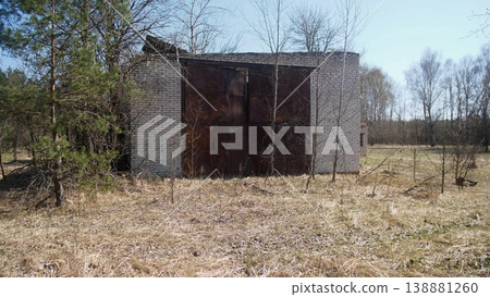 Isolated Concrete Bunker With Closed Metal Doors And Rust, Dry Grass And Birch Trees Surrounding Small Outbuilding, Locked Entrance Suggests Temporary Supply Cache Or Medic Outpost, Quiet Isolated Concrete Bunker With Closed Metal Doors And Rust, Dry Grass And Birch Trees Surrounding Small Outbuilding, Locked Entrance Suggests Temporary Supply Cache Or Medic Outpost, Quiet 138881260
