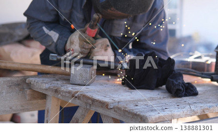 Metal Polishing Task. Worker Smooths Metal With Grinder. Polisher Refines Metal Edge Using Grinding Tool. Finishing Process Involves Smoothing And Bright Sparks In Workshop Metal Polishing Task. Worker Smooths Metal With Grinder. Polisher Refines Metal Edge Using Grinding Tool. Finishing Process Involves Smoothing And Bright Sparks In Workshop 138881301