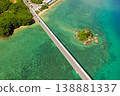 An aerial view of Kouri Bridge and a small island in Okinawa, seen from directly above, against the backdrop of the emerald green sea. 138881337