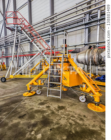 Yellow industrial mobile access platforms for aircraft engine maintenance, repair, and overhaul (MRO) in a service hangar. Aviation industry equipment. . High quality photo Yellow industrial mobile access platforms for aircraft engine maintenance, repair, and overhaul (MRO) in a service hangar. Aviation industry equipment. . High quality photo 138881409
