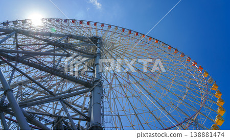 Osaka, Japan - Oct 11 2024, panoramic view from below of the Tempozan Ferris wheel against a blue sky, without people, in the daytime, Osaka, Japan Osaka, Japan - Oct 11 2024, panoramic view from below of the Tempozan Ferris wheel against a blue sky, without people, in the daytime, Osaka, Japan 138881474