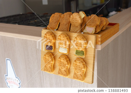 Kyoto, Japan - Oct 11 2025, A close-up view of a cafe counter with Taiyaki pies in the form of geisha with various fillings, without people, at daytime, Kyoto, Japan 138881493