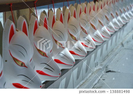 Kyoto, Japan - Oct 11 2024, A close-up to a row of white souvenir masks of Japanese kitsune foxes, Kyoto, Japan 138881498