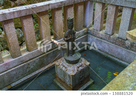 Kyoto, Japan - Oct 11 2025, Close-up view of a small bronze sculpture of a saint plased in a small stone pool, on the territory of Kiyomizu-dera Temple, without people, Kyoto, Japan Kyoto, Japan - Oct 11 2025, Close-up view of a small bronze sculpture of a saint plased in a small stone pool, on the territory of Kiyomizu-dera Temple, without people, Kyoto, Japan 138881520