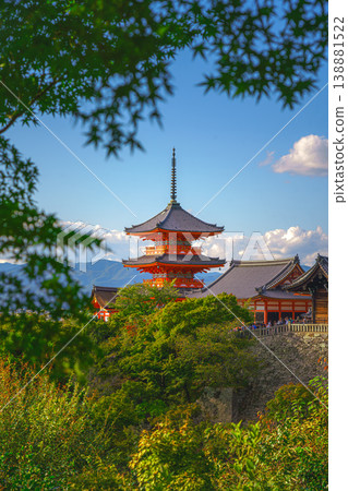 Kyoto, Japan - Oct 11 2024, vertical view through foliage of Kiyomizu-Dera temple complex with a pagoda, without people, with a clear blue sky and a forest in foreground, at daytime, Kyoto, Japan Kyoto, Japan - Oct 11 2024, vertical view through foliage of Kiyomizu-Dera temple complex with a pagoda, without people, with a clear blue sky and a forest in foreground, at daytime, Kyoto, Japan 138881522