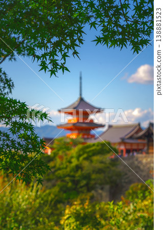 Kyoto, Japan - Oct 11 2024, vertical view through foliage of Kiyomizu-Dera temple complex with a pagoda, with a clear blue sky and a forest in foreground, at daytime, blurred, Kyoto, Japan Kyoto, Japan - Oct 11 2024, vertical view through foliage of Kiyomizu-Dera temple complex with a pagoda, with a clear blue sky and a forest in foreground, at daytime, blurred, Kyoto, Japan 138881523
