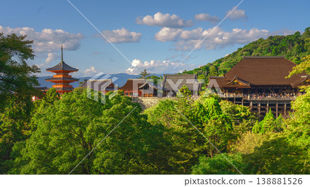 Kyoto, Japan - Oct 11 2024, panoramic view through foliage of Kiyomizu-Dera temple complex with a pagoda, without people, with a clear blue sky and a forest in foreground, at daytime, Kyoto, Japan 138881526