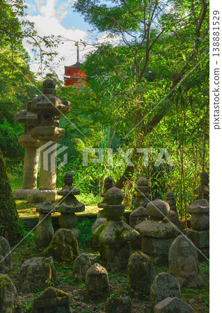 Kyoto, Japan - Oct 11 2024, panoramic view of cemetery with many moss-covered tombstones in form of stone pyramids or sculptures surrounded by trees on territory of Kiyomizu-dera Temple, Kyoto, Japan 138881529