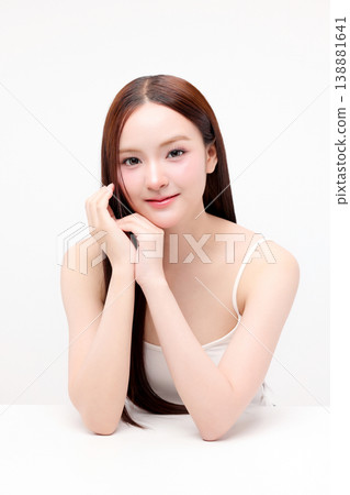 Portrait beautiful young Asian woman with K beauty style makeup and perfect skin on isolated white background. Facial and skin care concept for commercial advertising. Portrait beautiful young Asian woman with K beauty style makeup and perfect skin on isolated white background. Facial and skin care concept for commercial advertising. 138881641
