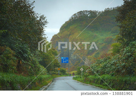Muroran, Hokkaido, Japan - Oct 4 2024, panoramic view of a country paved road passing through forests and fields, without cars and without people, in cloudy weather, at daytime, Muroran, Japan Muroran, Hokkaido, Japan - Oct 4 2024, panoramic view of a country paved road passing through forests and fields, without cars and without people, in cloudy weather, at daytime, Muroran, Japan 138881901