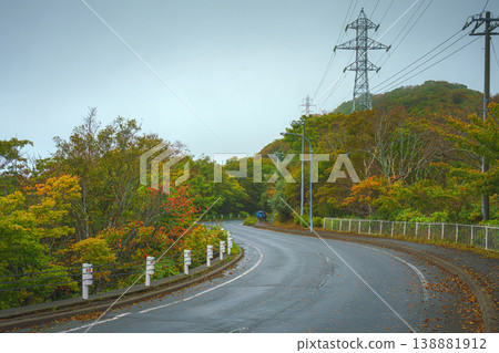 Muroran, Hokkaido, Japan - Oct 4 2024, panoramic view of a country paved road passing through forests and fields, without cars and without people, in cloudy weather, at daytime, Muroran, Japan Muroran, Hokkaido, Japan - Oct 4 2024, panoramic view of a country paved road passing through forests and fields, without cars and without people, in cloudy weather, at daytime, Muroran, Japan 138881912