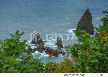 Muroran, Hokkaido, Japan - Oct 04 2024, panoramic aerial view of the picturesque Pacific ocean coast with sharp cliffs and high mountain slopes, in a storm, it's raining, at daytime, Muroran, Japan Muroran, Hokkaido, Japan - Oct 04 2024, panoramic aerial view of the picturesque Pacific ocean coast with sharp cliffs and high mountain slopes, in a storm, it's raining, at daytime, Muroran, Japan 138881929