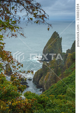 Muroran, Hokkaido, Japan - Oct 04 2024, vertical aerial view of the picturesque Pacific ocean coast with sharp cliffs and high mountain slopes, in a storm, it's raining, at daytime, Muroran, Japan Muroran, Hokkaido, Japan - Oct 04 2024, vertical aerial view of the picturesque Pacific ocean coast with sharp cliffs and high mountain slopes, in a storm, it's raining, at daytime, Muroran, Japan 138881934