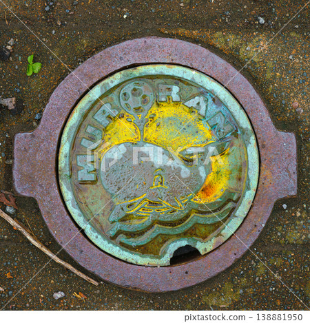 Muroran, Hokkaido, Japan - Oct 4 2024, close up view of a manhole cover with a cartoon whale and Muroran lettering on top, Muroran, Japan 138881950