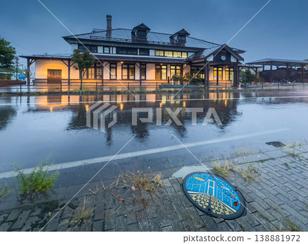 Muroran, Hokkaido, Japan - Oct 4 2024, panoramic view of Former Muroran Station Tourist Information Center with an illumination with a road covered with water in foreground, in evening, Muroran, Japan Muroran, Hokkaido, Japan - Oct 4 2024, panoramic view of Former Muroran Station Tourist Information Center with an illumination with a road covered with water in foreground, in evening, Muroran, Japan 138881972