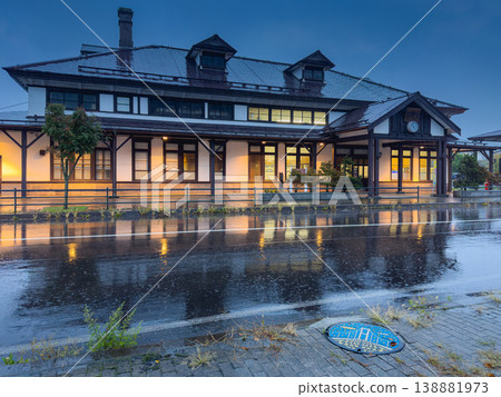 Muroran, Hokkaido, Japan - Oct 4 2024, panoramic view of Former Muroran Station Tourist Information Center with an illumination with a road covered with water in foreground, in evening, Muroran, Japan Muroran, Hokkaido, Japan - Oct 4 2024, panoramic view of Former Muroran Station Tourist Information Center with an illumination with a road covered with water in foreground, in evening, Muroran, Japan 138881973