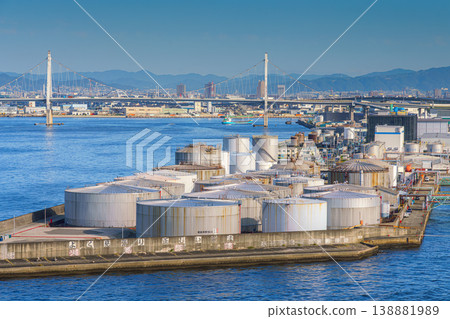 Osaka, Japan - Oct 11 2024, panoramic view from the water of oil storage tanks in the foreground, Konohana Bridge and cityscape of Osaka in the background, at daytime, Osaka, Japan Osaka, Japan - Oct 11 2024, panoramic view from the water of oil storage tanks in the foreground, Konohana Bridge and cityscape of Osaka in the background, at daytime, Osaka, Japan 138881989