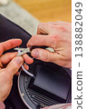 Close up of a person cutting insulation from an electrical wire using the scissors of a multitool. DIY electrical project.High quality photo 138882049